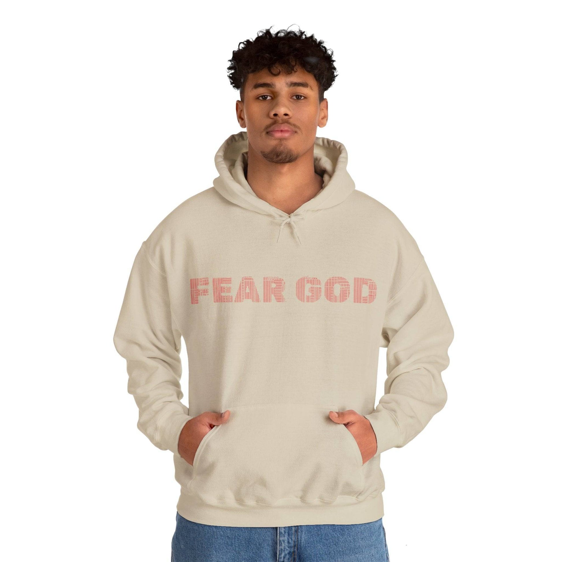 Person wearing beige hoodie with 'Fear God' text